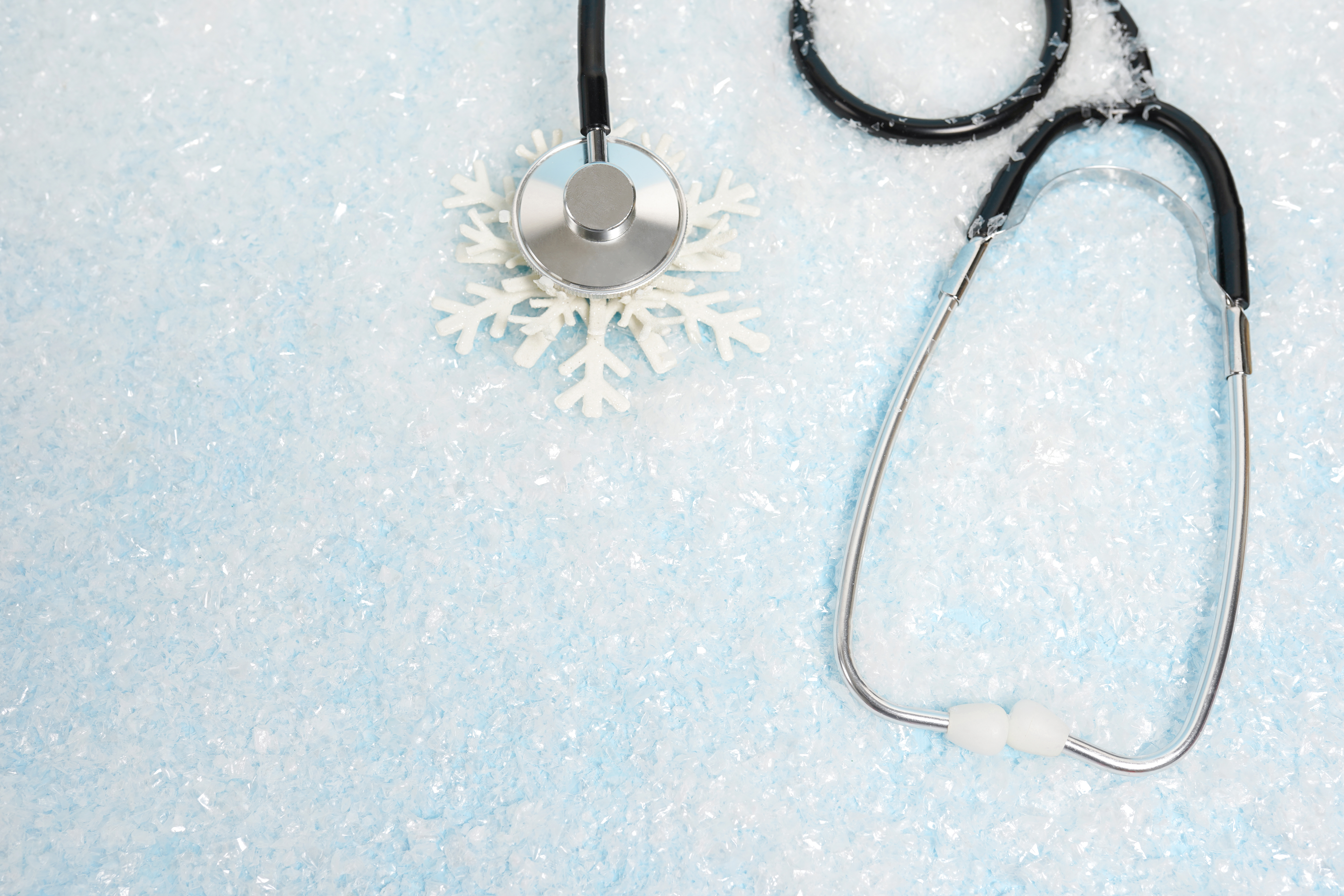 Stethoscope on a snowy blue background